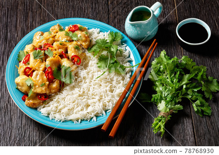 Mango glazed spicy chicken breast chunks with rice 78768930