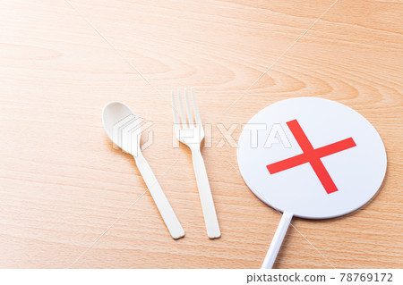 Plastic spoon, fork and cross mark Plastic spoon, fork and cross mark 78769172