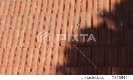 Orange color tile roof background. Close-up of the red clay texture of a house rooftop Orange color tile roof background. Close-up of the red clay texture of a house rooftop 78769434