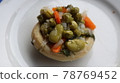 Healthy food Artichoke on the white plate. Close-up Artichoke food with beans, peas, onions and carrots. Delicious healthy vegan food with olive oil. 78769452