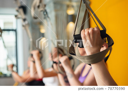 Close-up female hand during workout at fitness gym. Fitness, slimming and healthy lifestyle concept. Close-up female hand during workout at fitness gym. Fitness, slimming and healthy lifestyle concept. 78770390