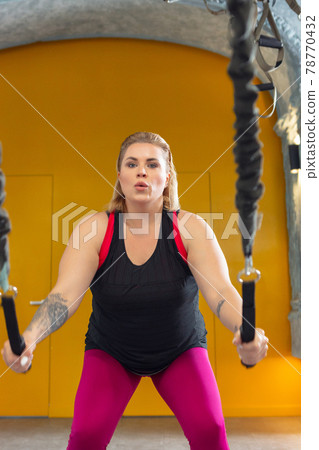 Young woman training with elastic rope in gym. Concept of healthy lifestyle, sport, fitness. 78770432