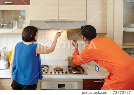 Handyman finding out kitchen hood problem Handyman finding out kitchen hood problem 78770737