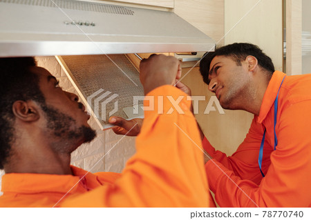 Men repairing kitchen hood Men repairing kitchen hood 78770740