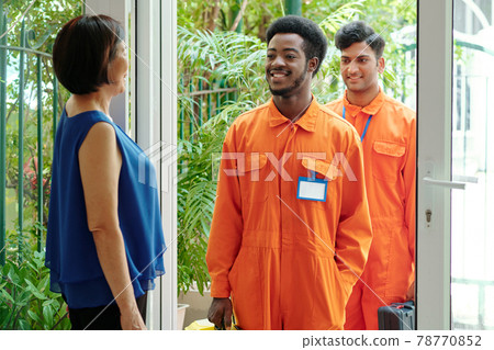 Multi-ethnic janitors coming in clients house Multi-ethnic janitors coming in clients house 78770852