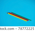 Yellow, Green and Red Pencils on Blue Background 78772225