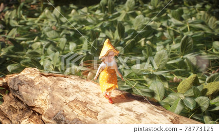 A cute little elf is resting and walking in the summer sunny green forest. Fairy elven magic concept. View of a fairy elf in a forest. 3D Rendering. 78773125
