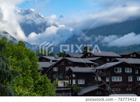 Historic buildings in Valais, Switzerland, with mountains in the background Historic buildings in Valais, Switzerland, with mountains in the background 78773412