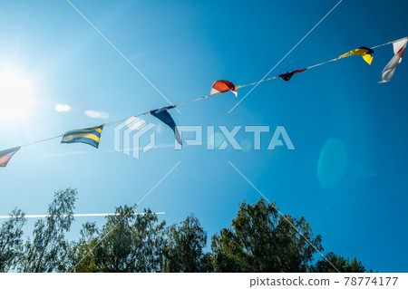 Nautical flags on the ship against blue sky 78774177