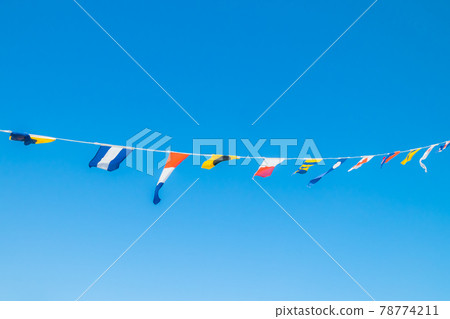 Nautical flags on the ship against blue sky Nautical flags on the ship against blue sky 78774211