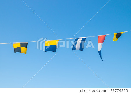 Nautical flags on the ship against blue sky 78774223
