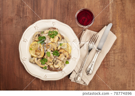 Overhead photo of scallopine di vitello, veal scallopini, with mushroom sauce Overhead photo of scallopine di vitello, veal scallopini, with mushroom sauce 78774896