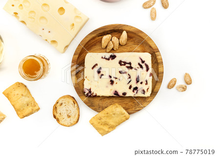 Overhead photo of cheese with cranberries on white 78775019