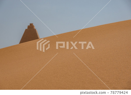 Tip of a pyramid behind a dune in Sudan, Sahara Tip of a pyramid behind a dune in Sudan, Sahara 78779424