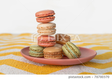 Pastel color macarons on plate gourmet dessert baking french pastry Pastel color macarons on plate gourmet dessert baking french pastry 78780370
