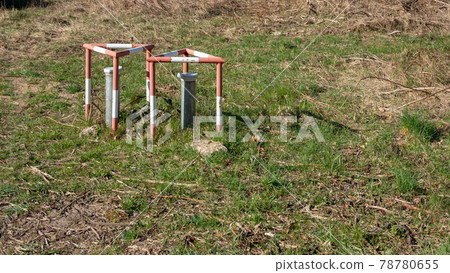 Groundwater measuring points with steel protection tube, end cap with hex locking and red and white concreted protection triangle Groundwater measuring points with steel protection tube, end cap with hex locking and red and white concreted protection triangle 78780655