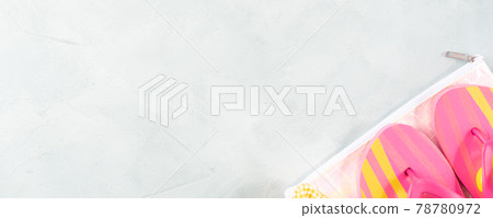 Summer bright stone background with colorful pink flip flops and beauty bag 78780972