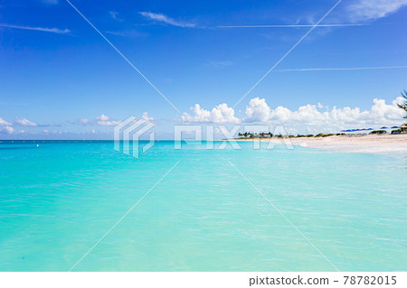 Idyllic tropical beach in Caribbean with white sand, turquoise ocean water and blue sky Idyllic tropical beach in Caribbean with white sand, turquoise ocean water and blue sky 78782015
