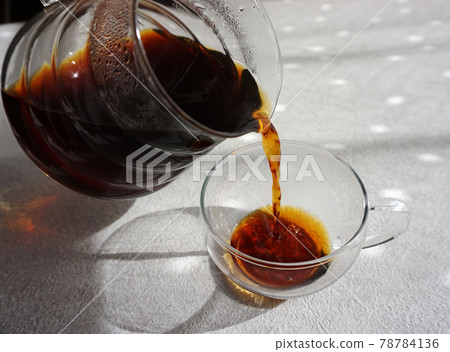 Pour coffee into a glass cup Pour coffee into a glass cup 78784136