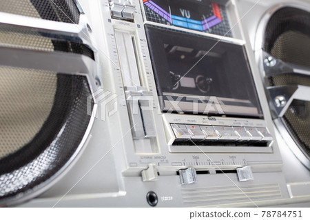 Vintage portable stereo boombox cassette recorder from 80s with reflection of blue and pink neon light. 78784751