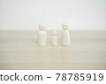 Family wooden peg doll on wood table. Family concept from peg doll. Selective focus. 78785919