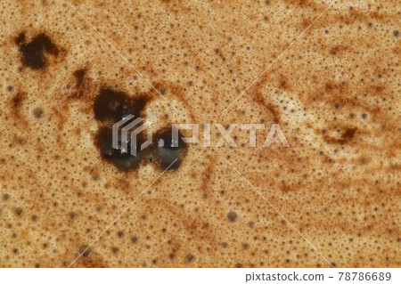 Macro shot of a cup of coffee with cream. Close-up of coffee with milk. Cappuccino or latte texture with foamy, close-up top view macro 78786689