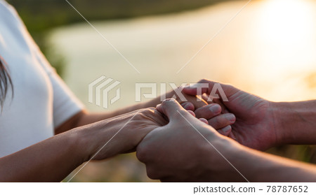 Two partner holding hand in front of the mountain during sunset. Friendship, Happiness, Leisure, Partnership and team Concept. 78787652