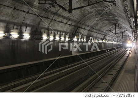 Seikan Tunnel Yoshioka Kaitei Station platform and approaching train 78788057