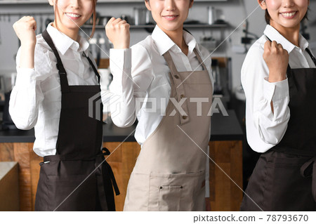 Image of multiple women in aprons working in a restaurant doing guts poses Image of multiple women in aprons working in a restaurant doing guts poses 78793670