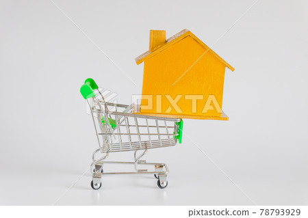 Golden house with shopping cart trolley ,Housing and Real Estate concept. 78793929
