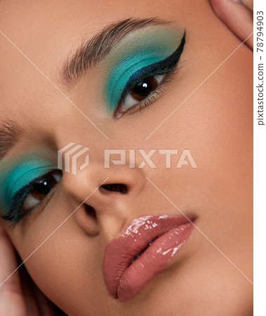 young woman with blue eye shadow makeup 78794903