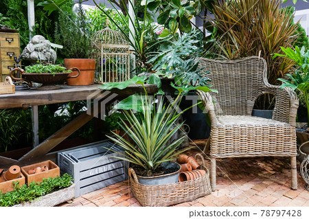 Chair in the garden. Chair on a wooden walkway. Balcony in the garden. 78797428