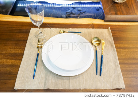 modern ceramic tableware in dining room with table set ready for a nice meal modern ceramic tableware in dining room with table set ready for a nice meal 78797432