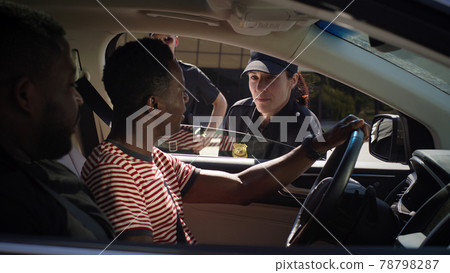 Black men discussing police officer in vehicle Black men discussing police officer in vehicle 78798287