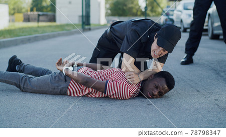 Diverse police officers arresting African American man 78798347