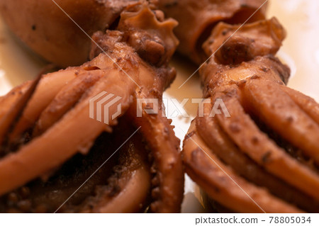 Close-up of two small baby squids cooked in soy sauce Close-up of two small baby squids cooked in soy sauce 78805034