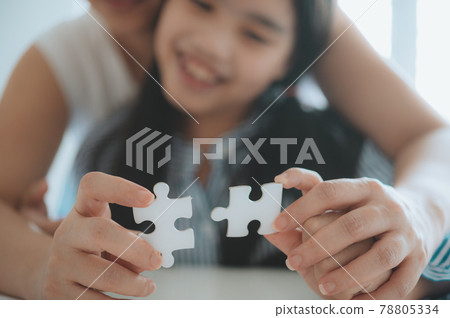 Happy family, Asian daughter playing jigsaw puzzle with her mother for family concept, Adult woman teaches child to solve puzzles, , success and strategy concept 78805334
