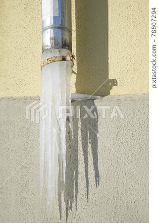 large icicle on a light background close-up 78807294