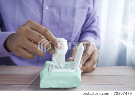 hand pick cleansing wet wipes on table with copy space hand pick cleansing wet wipes on table with copy space 78807479