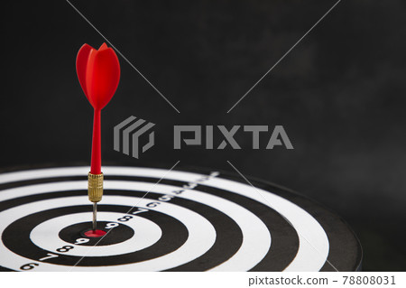 Close up shot of the dart arrow hit on bullseye, red dart arrow hitting in the target center of dartboard Target hit in the center, challenge in business marketing,Target and goal as concept. Close up shot of the dart arrow hit on bullseye, red dart arrow hitting in the target center of dartboard Target hit in the center, challenge in business marketing,Target and goal as concept. 78808031