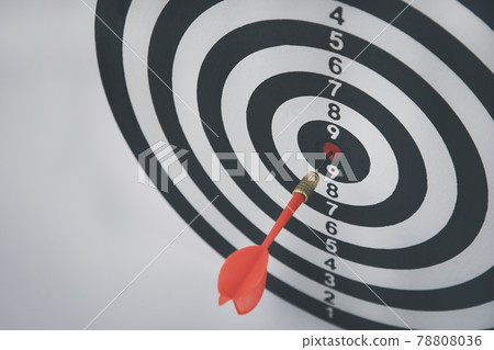 Close up shot of the dart arrow hit on bullseye, red dart arrow hitting in the target center of dartboard Target hit in the center, challenge in business marketing,Target and goal as concept. 78808036
