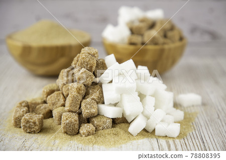 Bowl wood and and white and Brown sand sugar and lump sugar on dark background Bowl wood and and white and Brown sand sugar and lump sugar on dark background 78808395