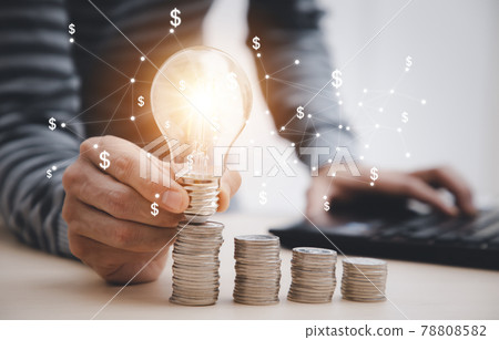 thinking and creative with Coins and light bulb concept,Close up light bulb and working on the desk, Creativity and innovation are keys to success.Concept of new idea and innovation with Brain. thinking and creative with Coins and light bulb concept,Close up light bulb and working on the desk, Creativity and innovation are keys to success.Concept of new idea and innovation with Brain. 78808582