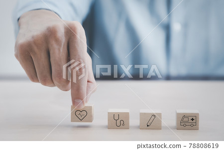 Close up customer hand choose health icon on wood cube, Health medical Insurance Concept, Hand arranging wood cube with medical symbol on pastel white background, copy space. 78808619