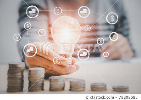 Businessman hand Holding Light Bulb with Coins stacking on desk, Businessman hand Holding Light Bulb with Coins stacking on desk, 78808685