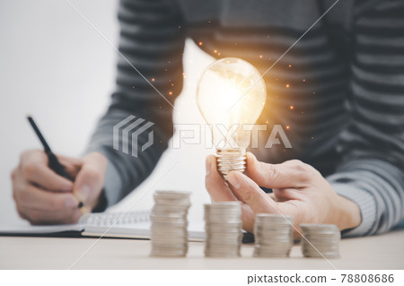 Businessman hand Holding Light Bulb with Coins stacking on desk, Businessman hand Holding Light Bulb with Coins stacking on desk, 78808686