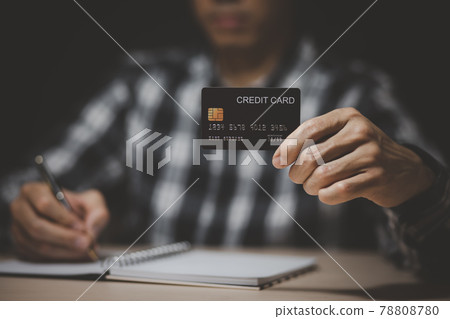 Businessman holding credit card and using laptop computer. Online shopping concept,banking and online shopping at the home.Close up. Businessman holding credit card and using laptop computer. Online shopping concept,banking and online shopping at the home.Close up. 78808780