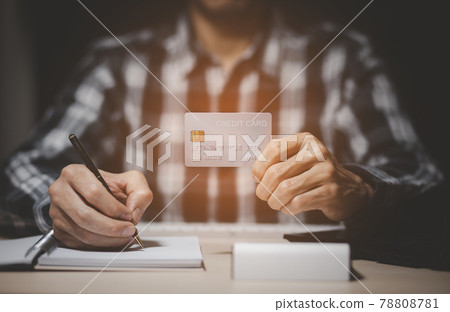 Businessman holding credit card and using laptop computer. Online shopping concept,banking and online shopping at the home.Close up. Businessman holding credit card and using laptop computer. Online shopping concept,banking and online shopping at the home.Close up. 78808781