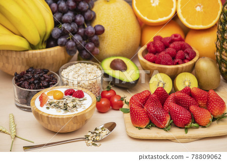 Group Fruits mixed with banana, orange, strawberry and nuts, concept health food and diet, vegetarian food in the top view on the wood table. 78809062