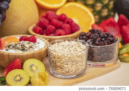 Group Fruits mixed with banana, orange, strawberry and nuts, concept health food and diet, vegetarian food in the top view on the wood table. 78809071